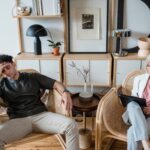 A stressed man and woman therapist in a modern consultation room.